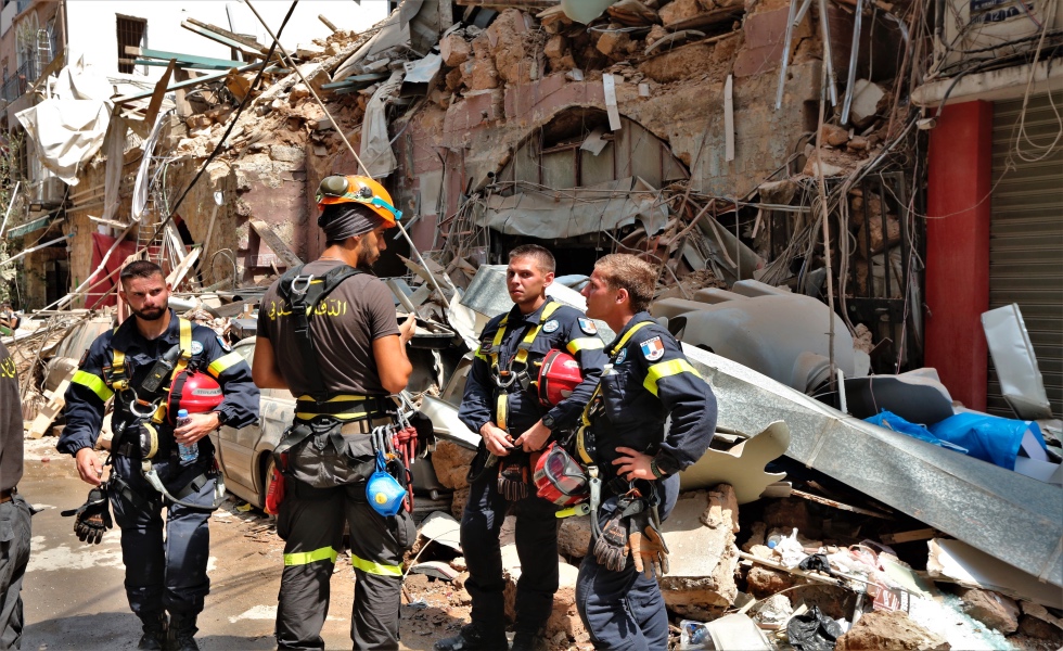 Beirut (Lebanon), 06/08/2020.- French civil defense stand around a damaged area in Beirut, Lebanon, 06 August 2020. According to the Lebanese Health Ministry, at least 137 people were killed, and more than 5,000 injured in the blast believed to have been caused by an estimated 2,750 of ammonium nitrate stored in a warehouse. The explosion and its shockwave on 04 August 2020 devastated the port area and parts of the city. (Líbano) EFE/EPA/NABIL MOUNZER