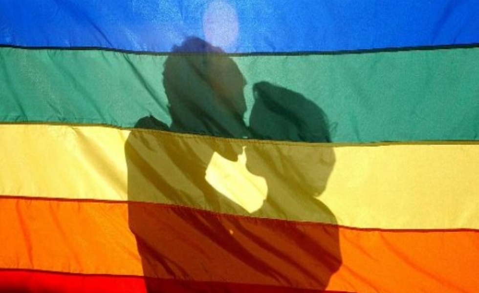pareja-gay-lgbti-beso-bandera-efe
