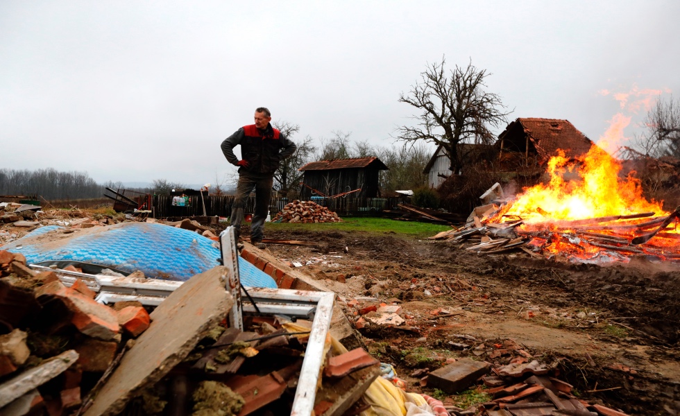 Majske Poljane (Croatia), 04/01/2021.- A man stands in front his destroyed house and burns debris in the Majske Poljane village near Glina, 04 January 2021. The 6.4 magnitude earthquake that struck Croatia on 29 December 2020 left many houses in Petrinja, Sisak and the Glina area damaged or destroyed and another 4.2 magnitude aftershock was measured earlier on 04 January 2021. The 29 December 2020 earthquake left numerous people injuried and at least seven people dead. (Terremoto/sismo, Croacia) EFE/EPA/ANTONIO BAT