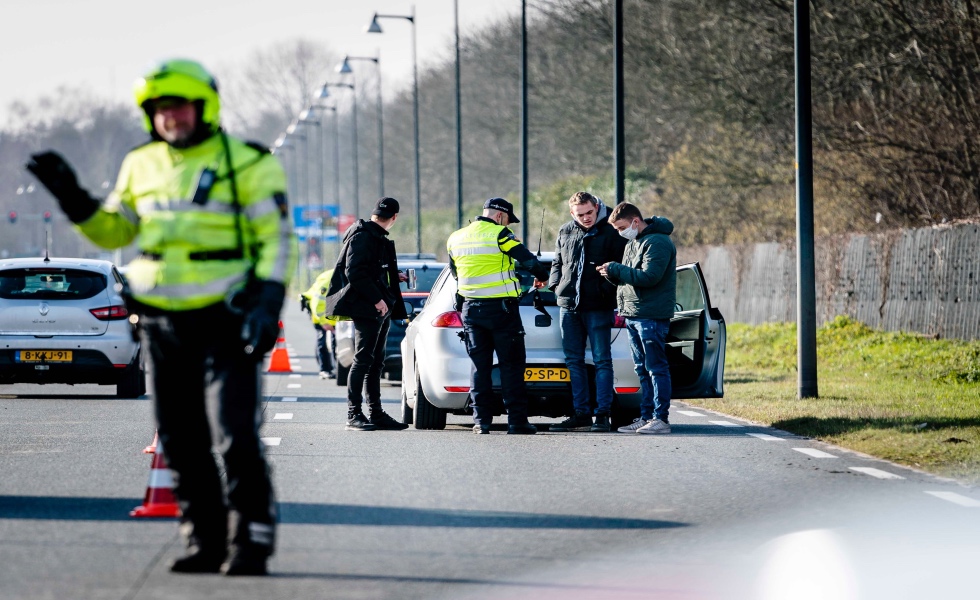 Apeldoorn (Netherlands), 31/01/2021.- A police officer checks passengers on an access road in Apeldoorn, Netherlands, 31 January 2021. Riots against coronavirus restrictions are expected in the Municipality of Apeldoorn pushing the police to take precautionary measures. (Disturbios, PaÌses Bajos; Holanda) EFE/EPA/ANP10